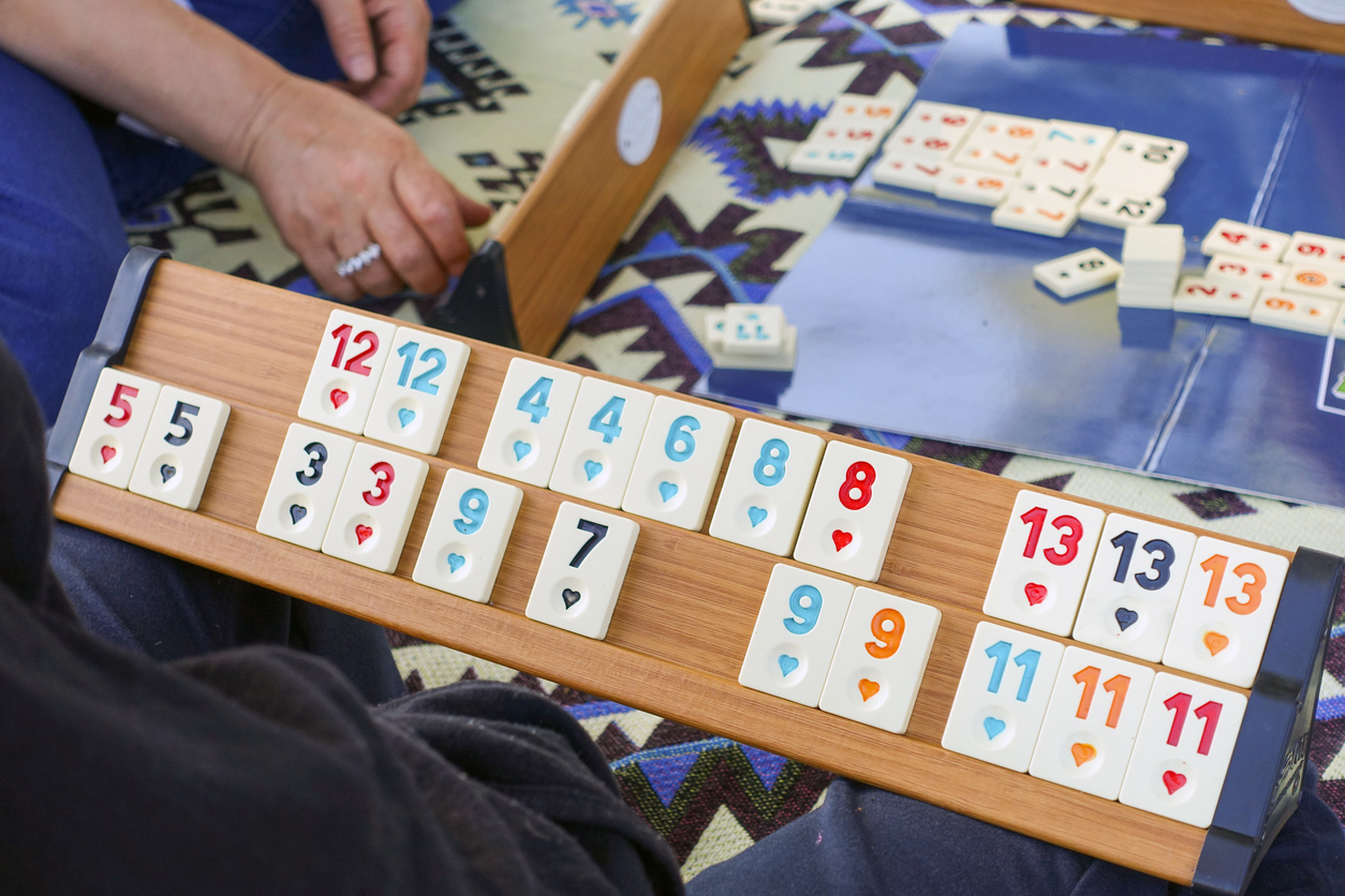 individuals playing okey at the family picnic, people playing color okey at the picnic,